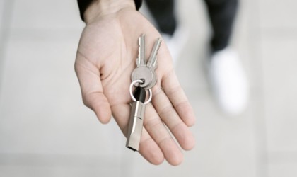 Person holding set of keys with charging cable key chain