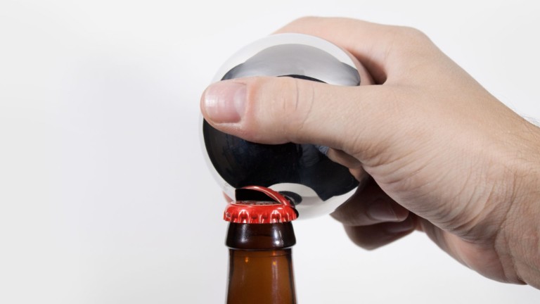 Convex bottle opener has an elegant design borrowed from heavy industry