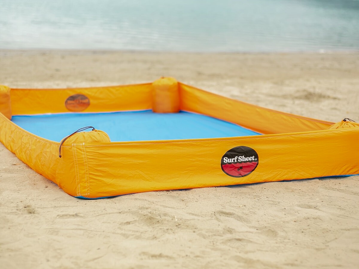 Surf Sheet sand-free beach blanket uses upright sides to keep sand off the flat surface