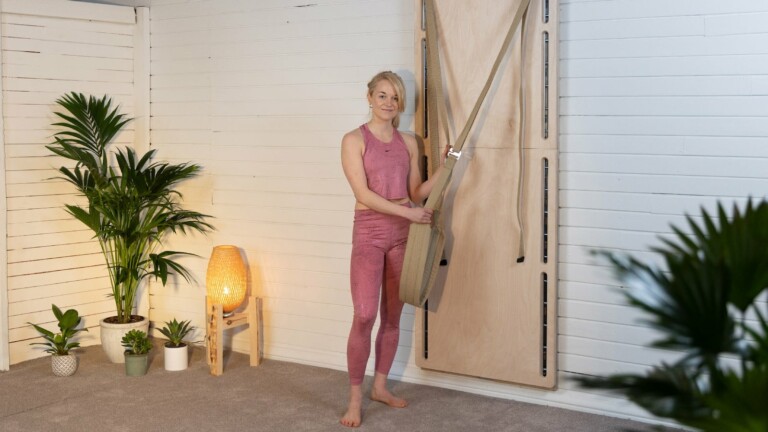 Compact Yoga Wall adapts to any space and works with an app for customized sessions