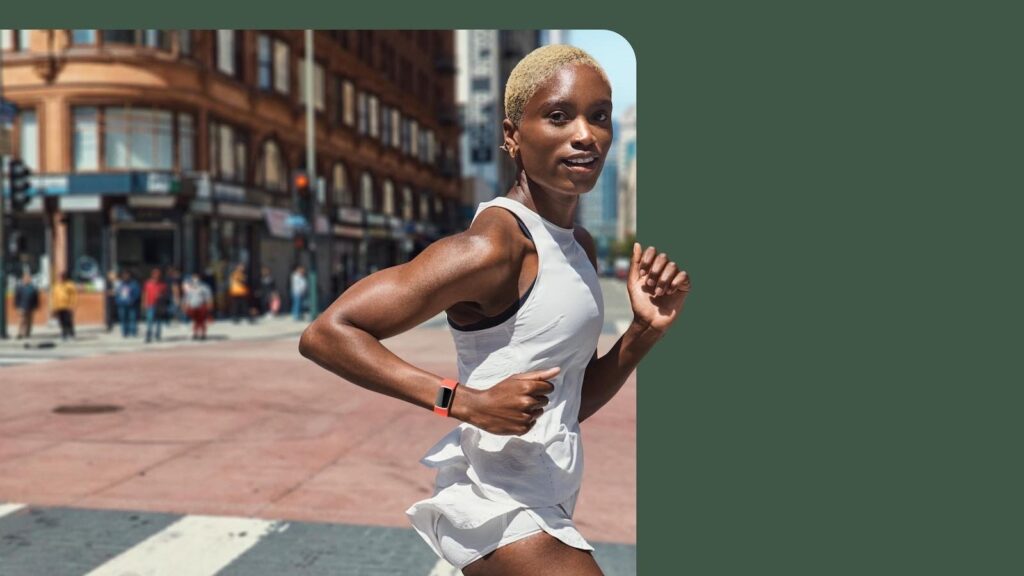 Woman running with the Fitbit Charge 6