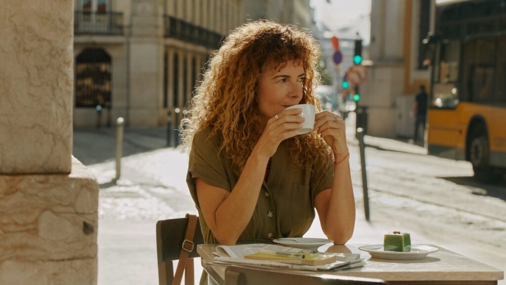 Whoop vs Oura: Oura Ring 4 on a woman drinking coffee